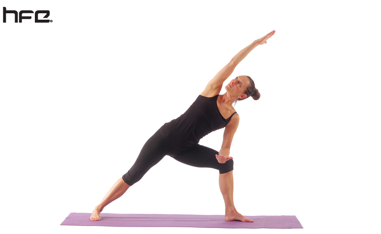 Female performing an extended side angle pose for low back pain