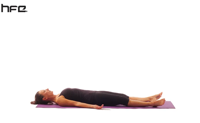 A female yoga instructor performing the Corpse Pose