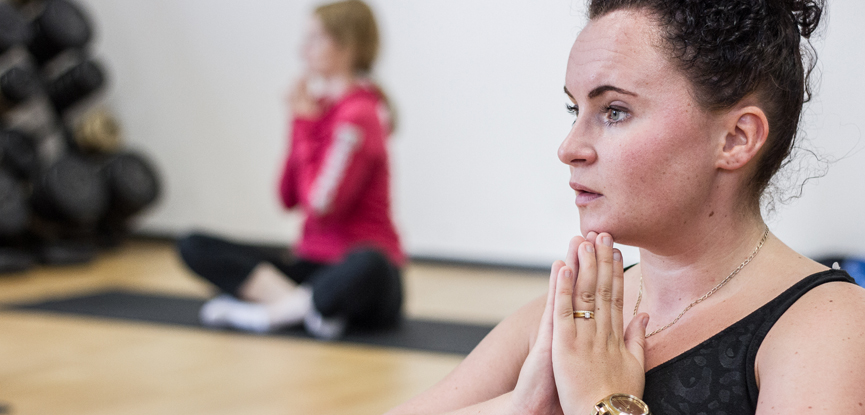 Adults attending a Pilates class