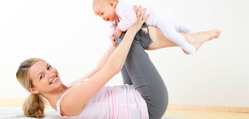 A woman performing an exercise with her baby