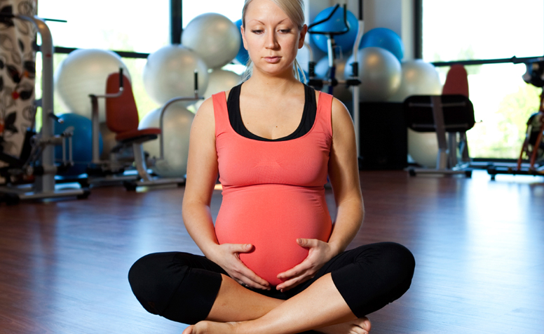 Pregnant woman attending a yoga class