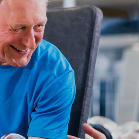 Fitness trainer working with an elderly client