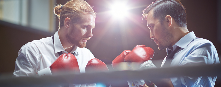 Two office workers in a boxing ring