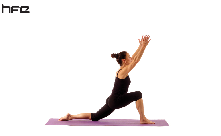 A yoga teacher performing the lunge pose