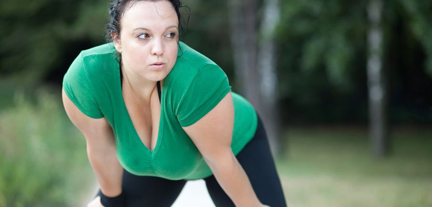 An overweight woman exercising