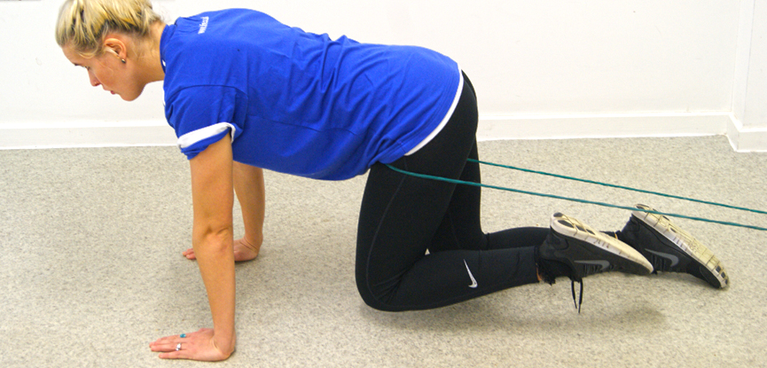 Support tutor Dani performs a hip floss exercise