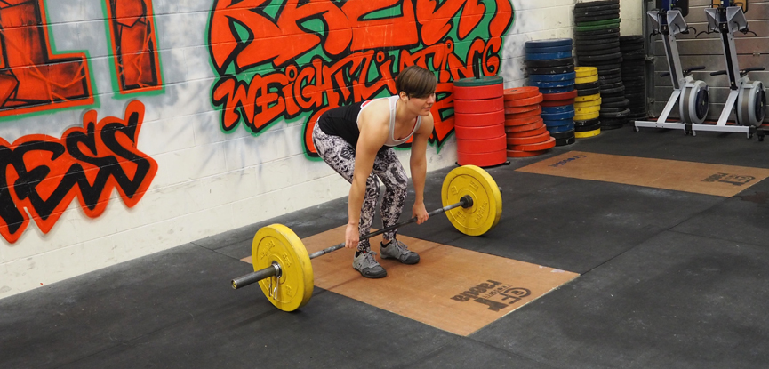 Georgina demonstrates the conventional grip for a deadlift