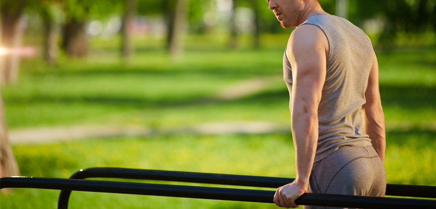 A man using outdoor equipment to exercise