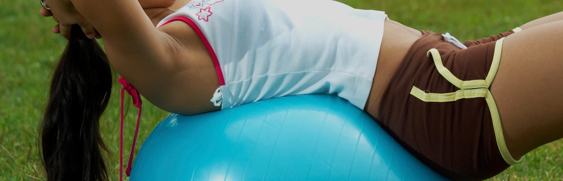 Outdoor training student stretching on an exercise ball