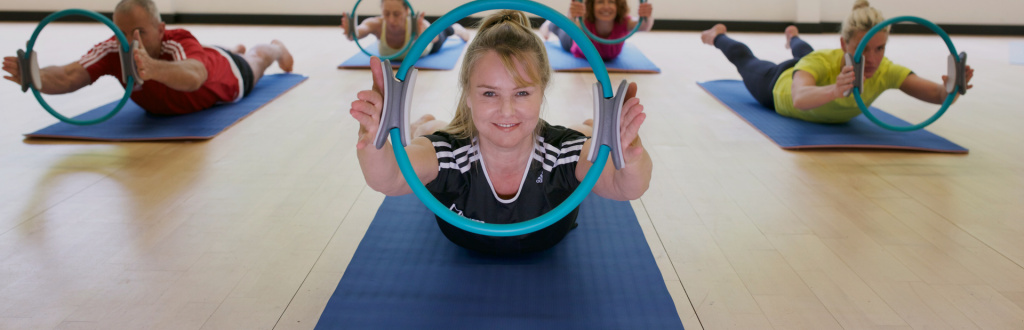 An HFE tutor delivering Pilates instructor courses with a Pilates circle