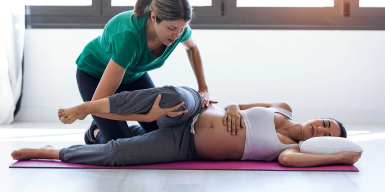 Pilates teacher with pregnant woman