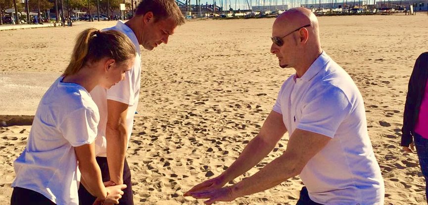 Personal trainer Iain Bainbridge training clients on a beach