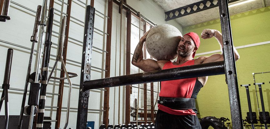 Former Gladiator James Crossley lifting an Atlas stone