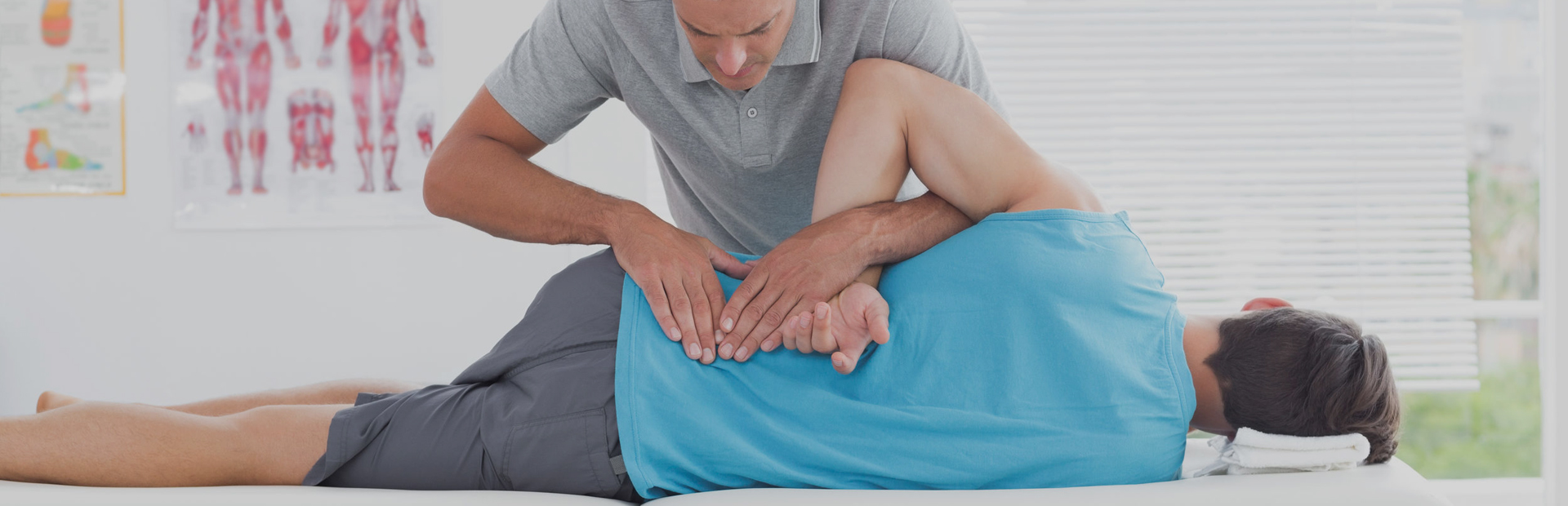 Sports massage therapist examining a client