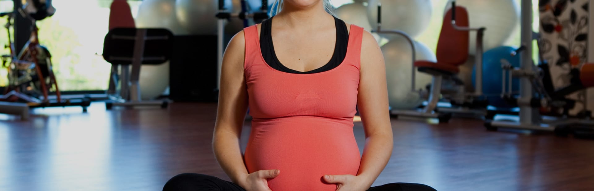 Pregnant client sitting in an exercise studio