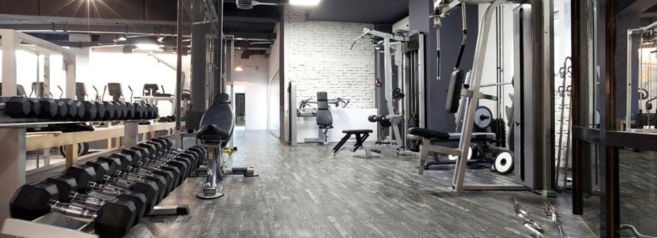 A fully equipped gym with resistance machines and weights
