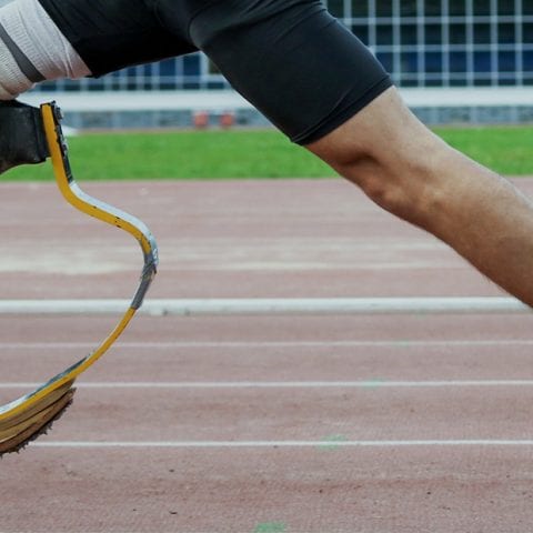 An amputee athlete running on a race track