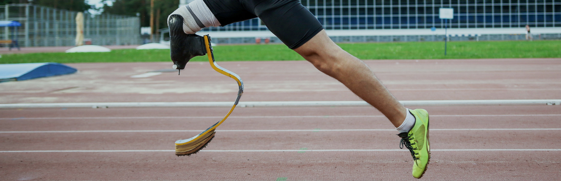 An amputee athlete running on a race track