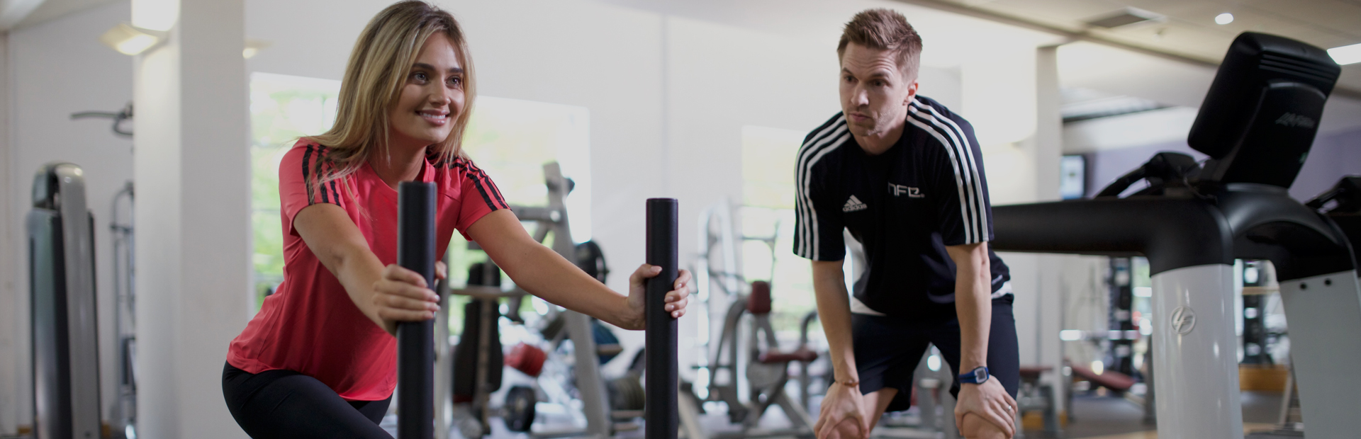 An HFE personal trainer working with a client