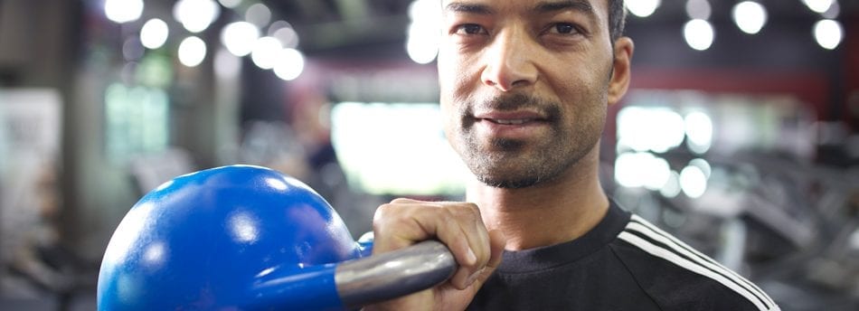 HFE personal training tutor holding a kettlebell