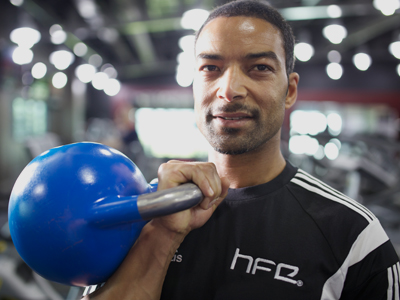 HFE personal training tutor holding a kettlebell
