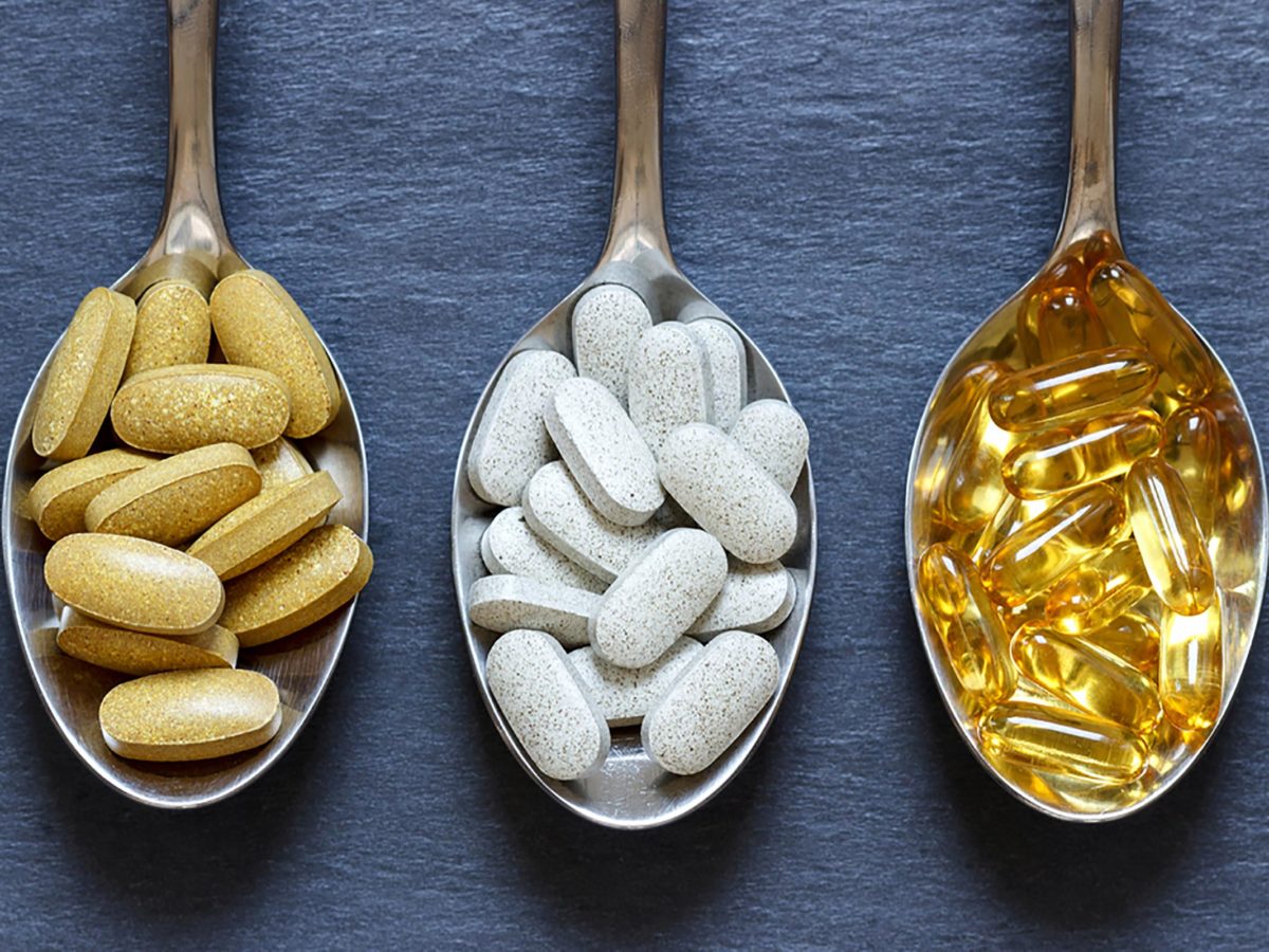 Vitamins and supplements on spoons