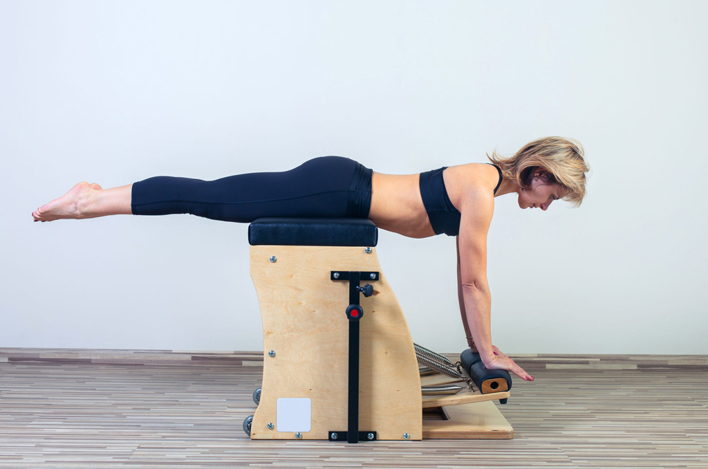 Female class participant using a Pilates chair