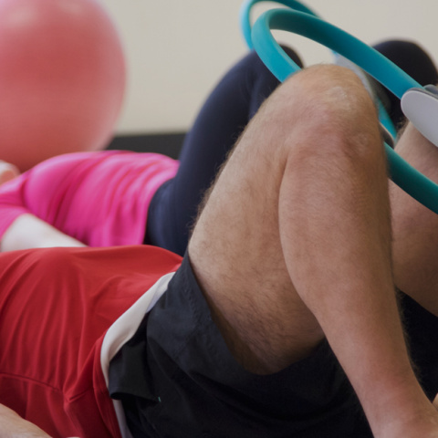 Pilates students in a class using Pilates circles