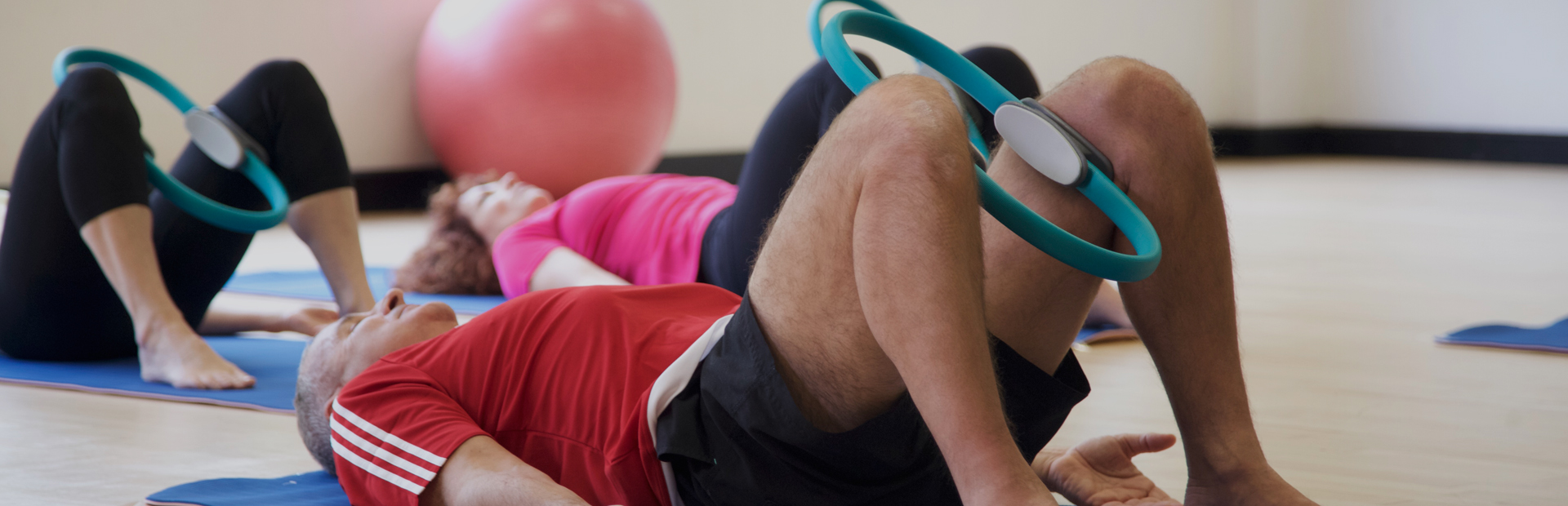 Pilates students in a class using Pilates circles