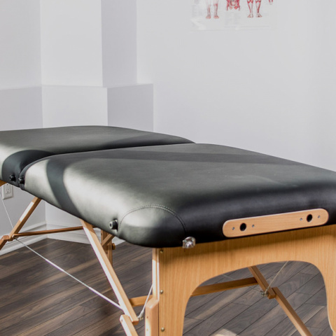 Massage therapy studio with a massage bed