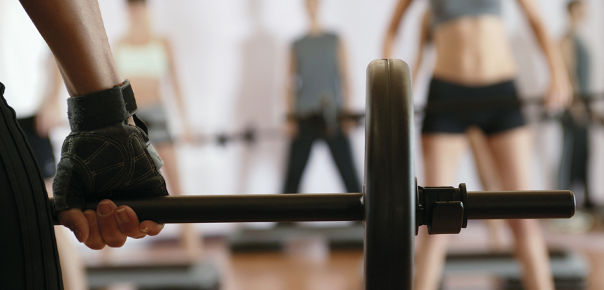 A group exercise class with participants lifting weights