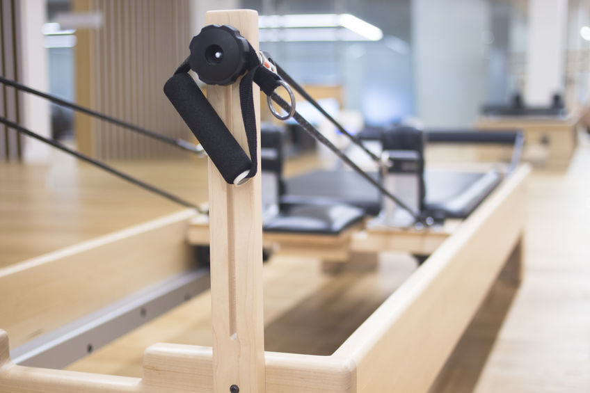 A reformer Pilates machine in a studio