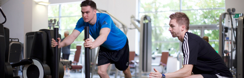 HFE personal trainer tutor working a student on a prowler