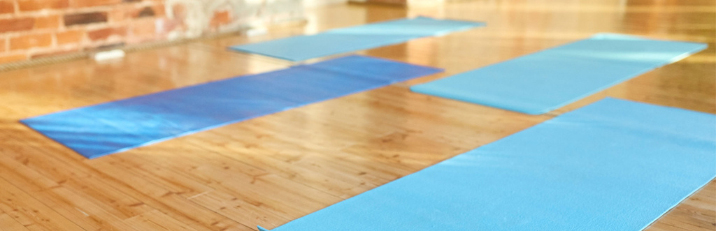 Pilates mats arranged in a boutique studio