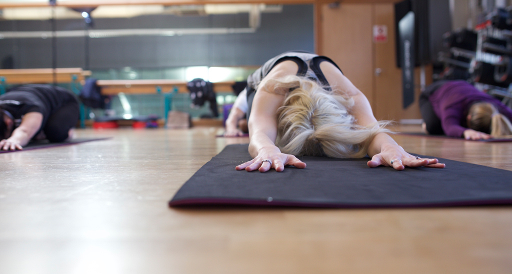 Students performing child's pose in a yoga class