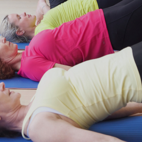 Students performing bridge pose to stretch the psoas muscles