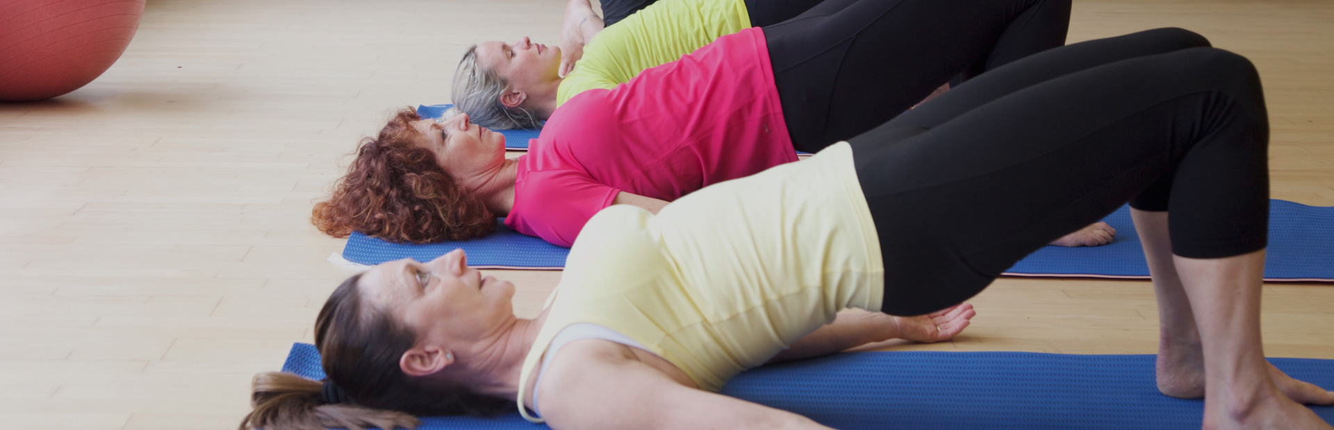 Students performing bridge pose to stretch the psoas muscles