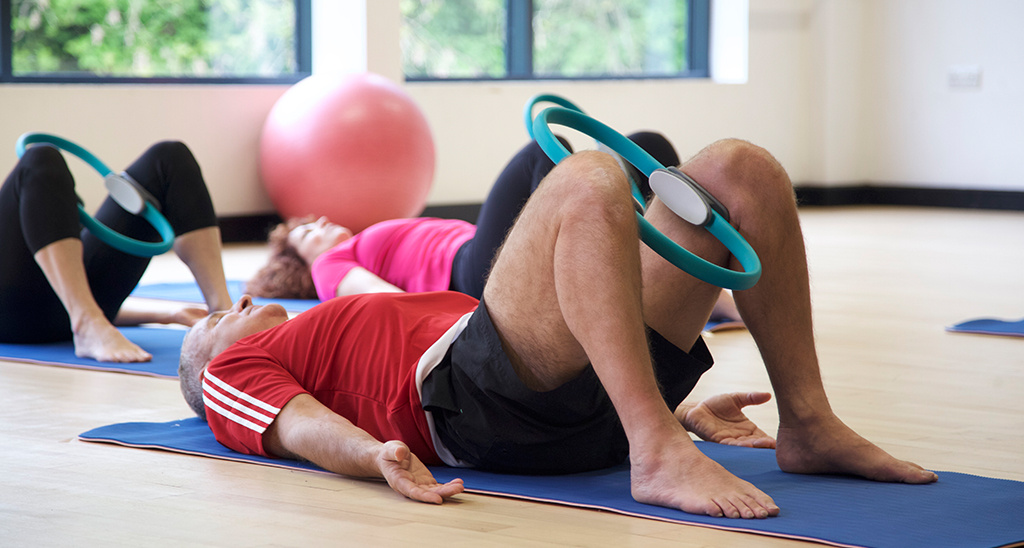 A mixed ability Pilates class using a circle as a prop