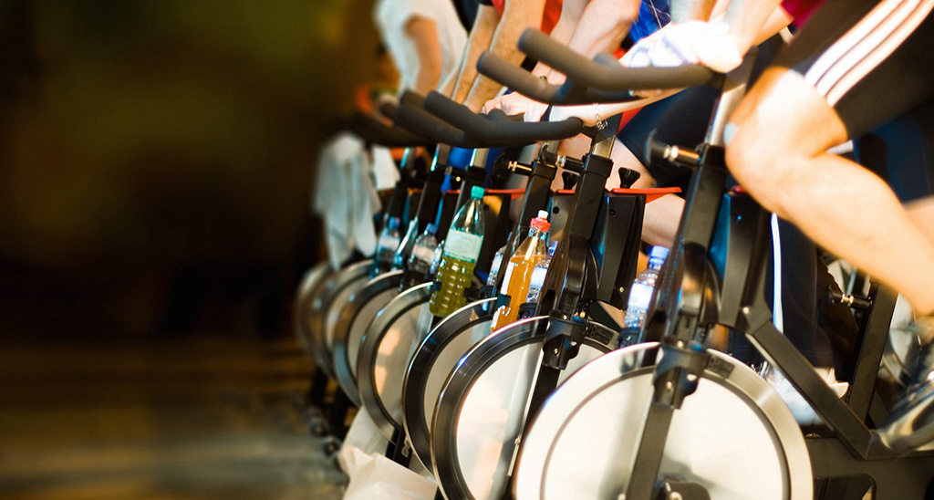 People taking part in an indoor cycling class