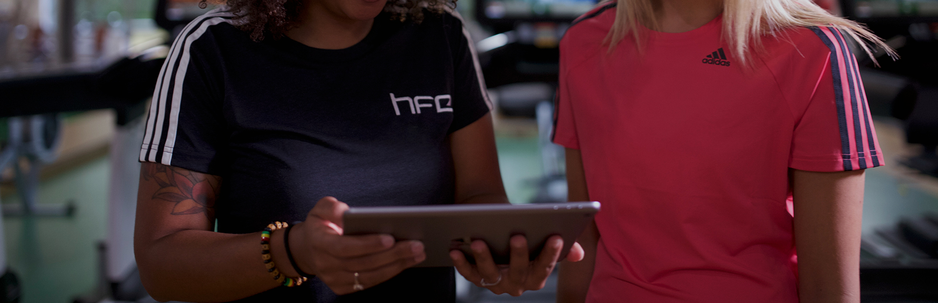 Fitness professional using an iPad with a client
