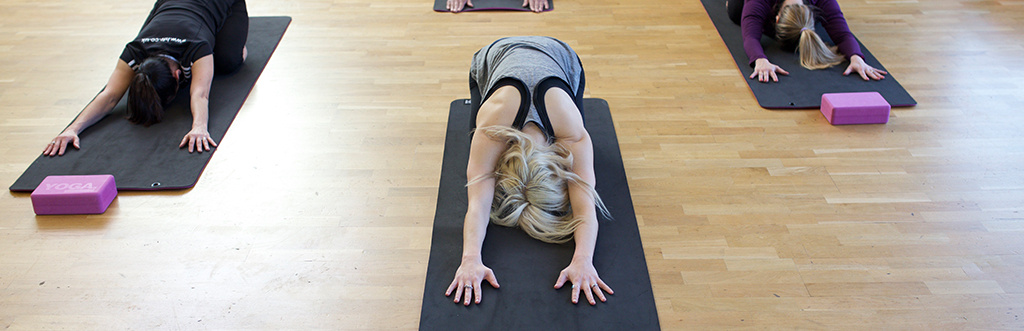 Yoga students performing child's pose