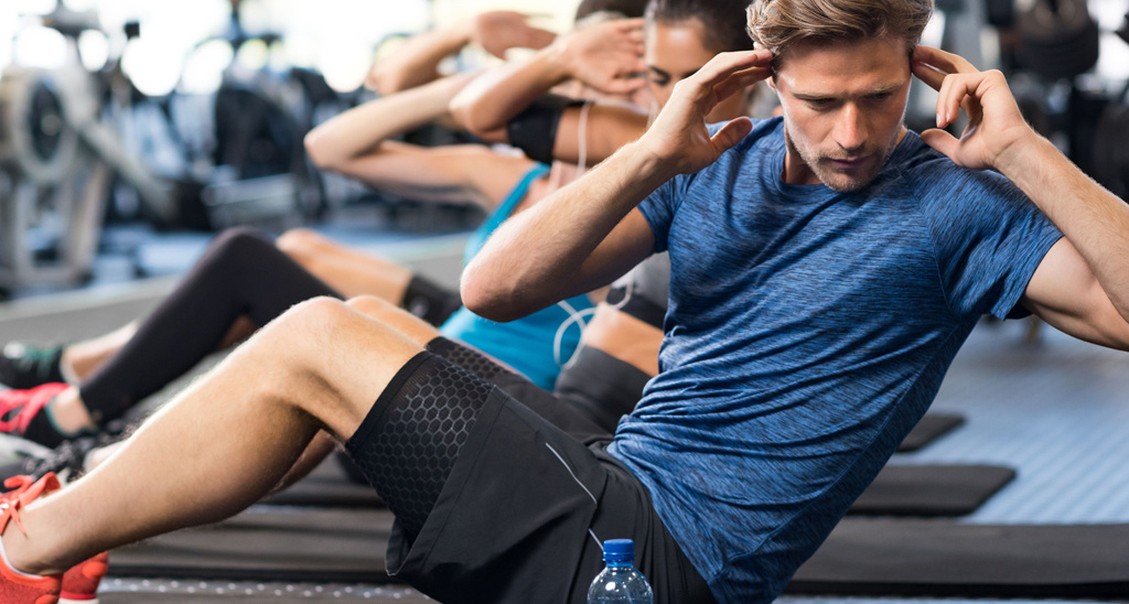 Men and women taking part in a boutique exercise class