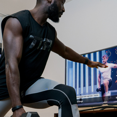 A man using Fiit in his living for an online workout