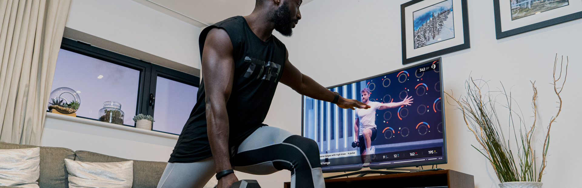 A man using Fiit in his living for an online workout