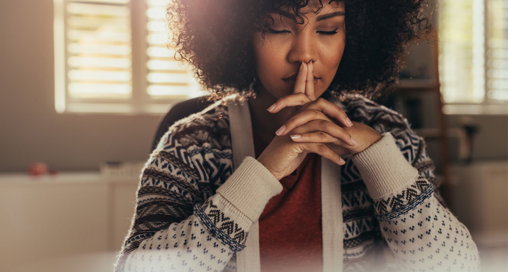 A young woman engaged in mindfulness meditation