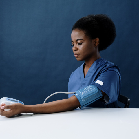 woman testing her own blood pressure
