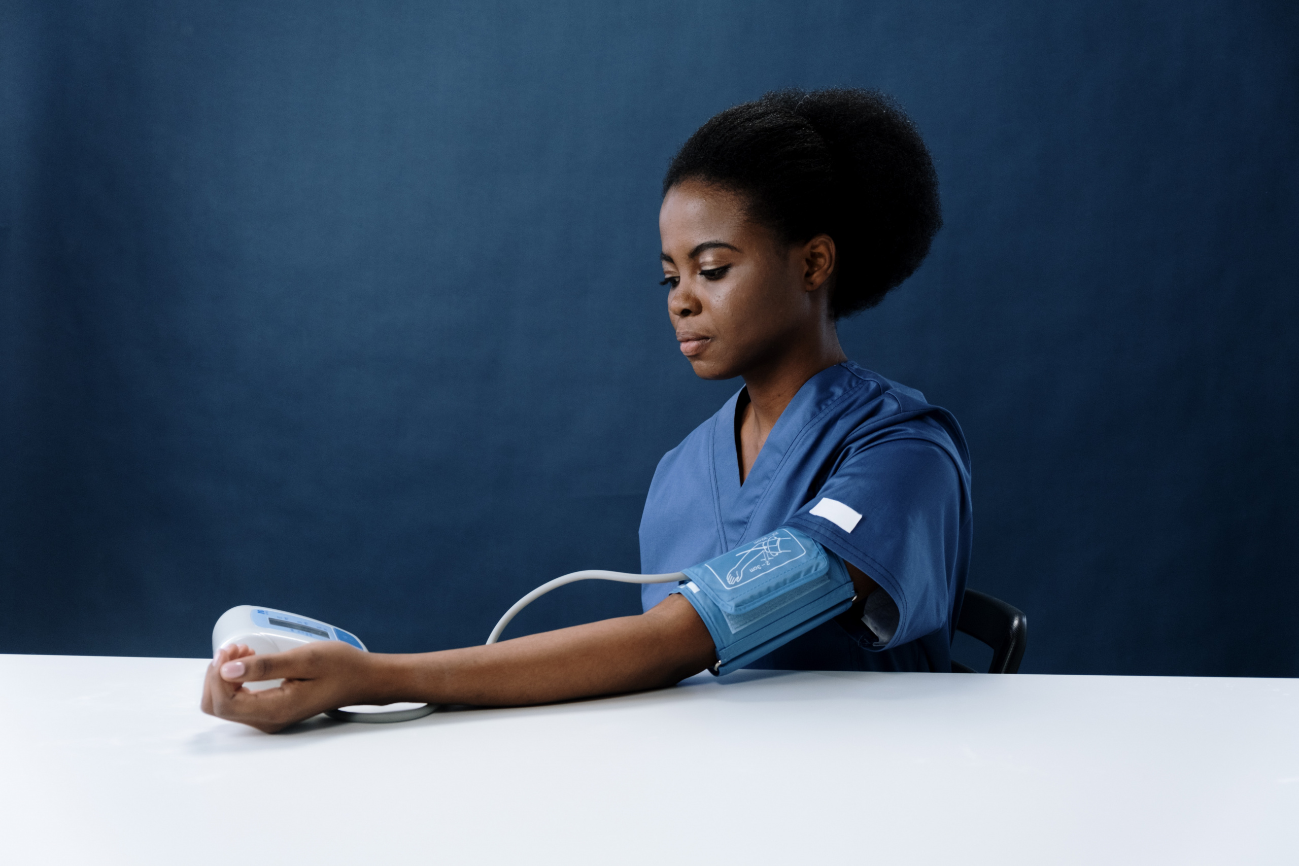 woman testing her own blood pressure