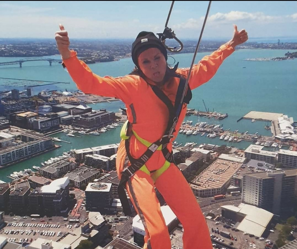 Natasha Arnold at top of tall building in harness