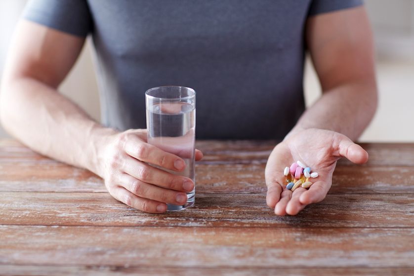 Supplement tablets and glass of water