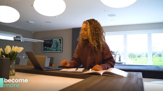 HFE student studying at home with MacBook and textbooks